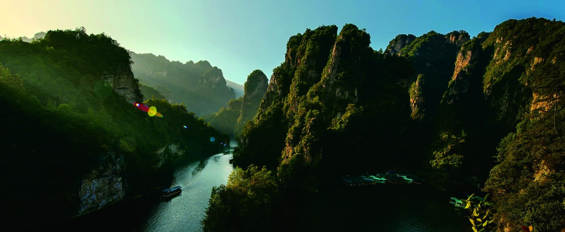 Panoramic Baofeng Lake between steep forested cliffs