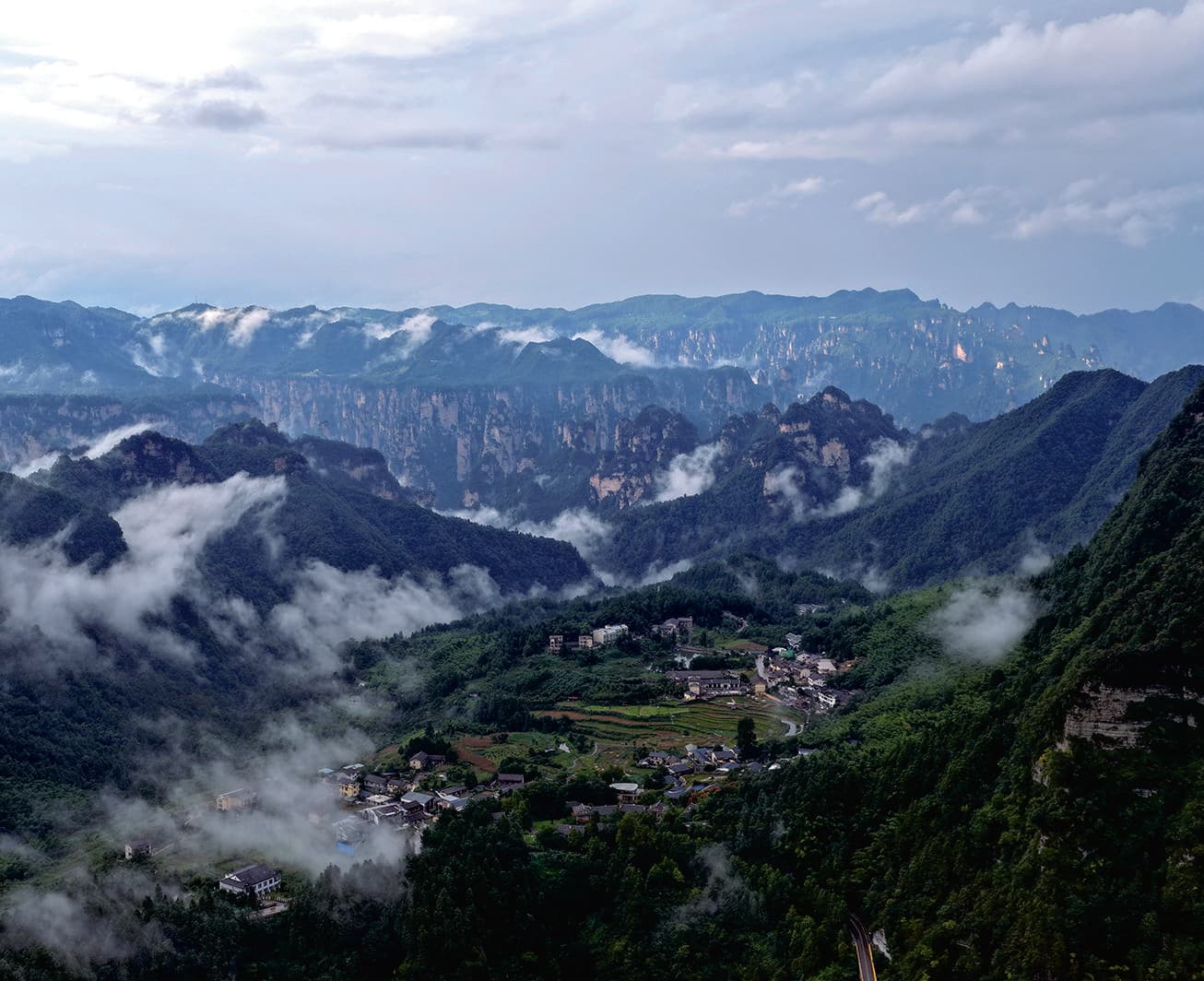 Longweiba Community below misty Zhangjiajie peak forests