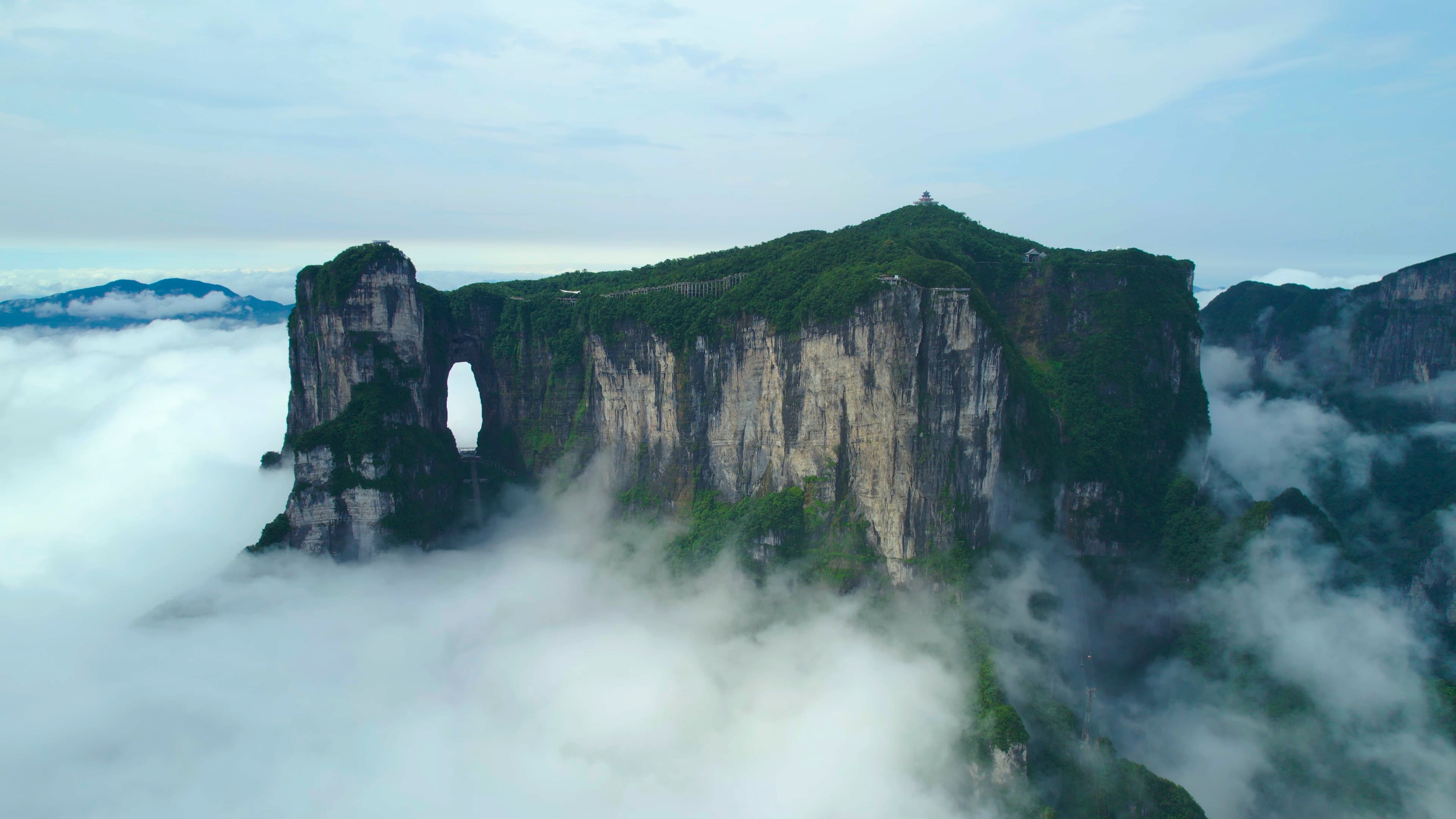 Tianmen Cave and its surrounding cliffs above a sea of clouds