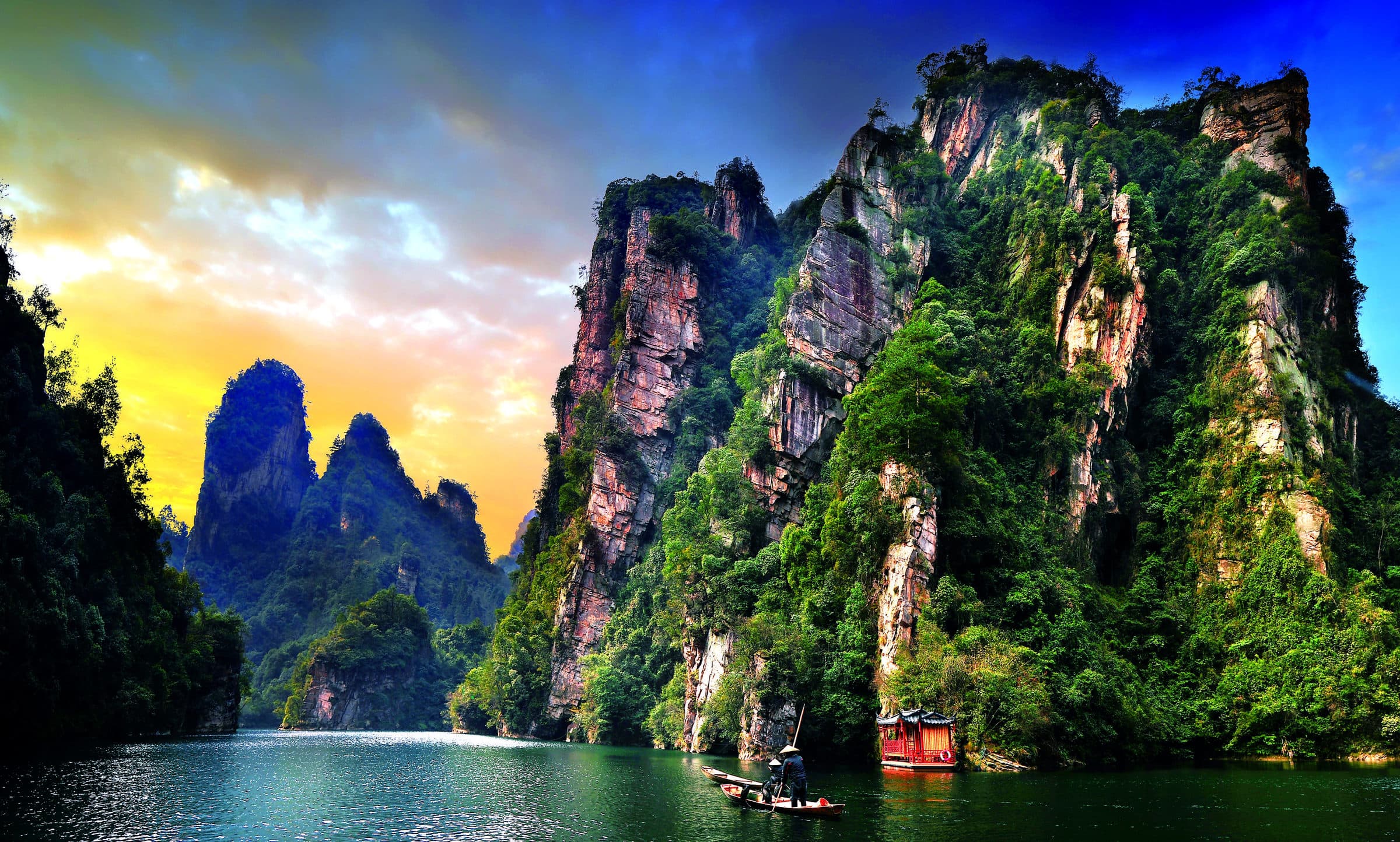 Boat on Baofeng Lake beneath forested cliffs in the official Wulingyuan brochure