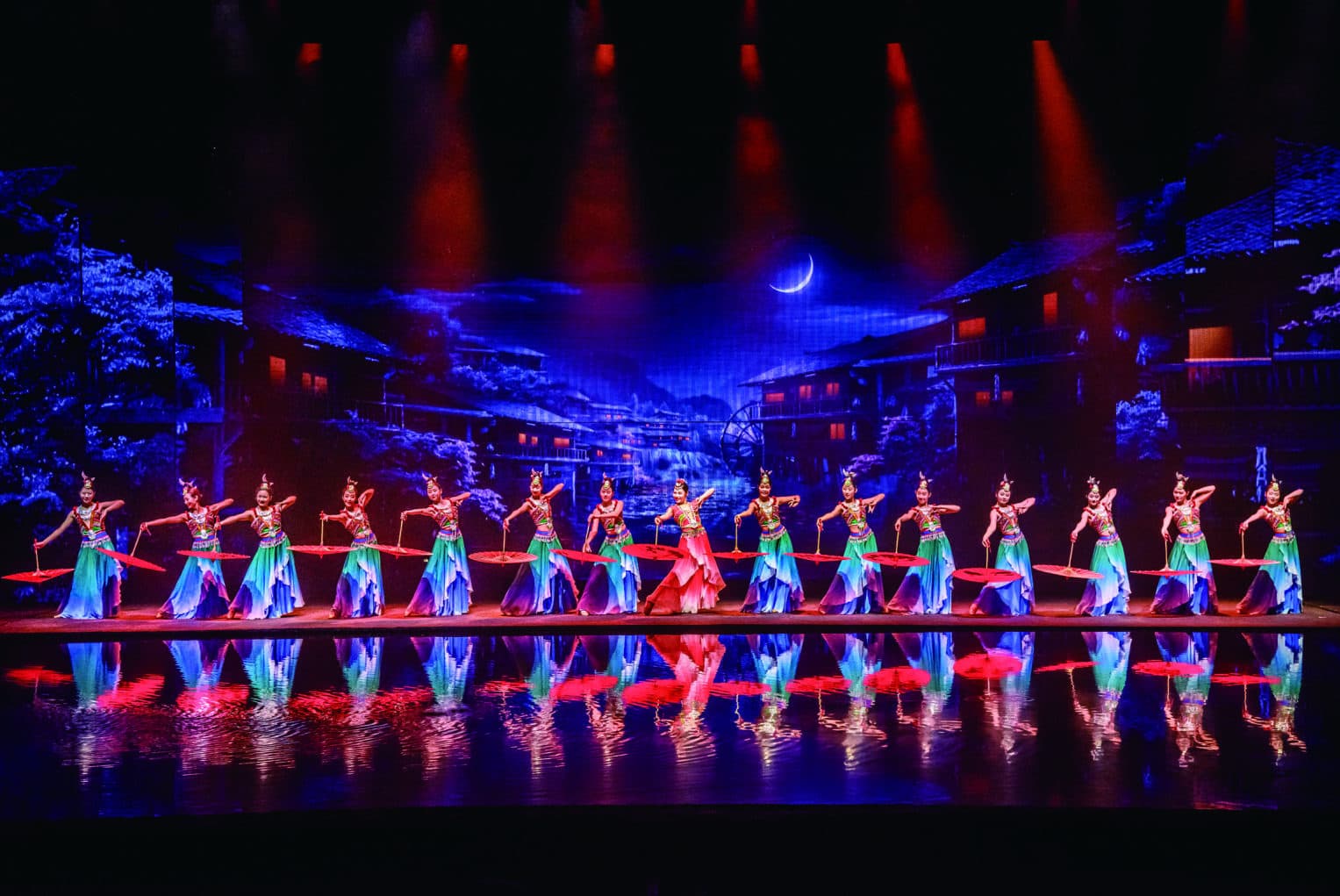 Zhangjiajie Eternal Love dancers under red stage light in the official Wulingyuan brochure