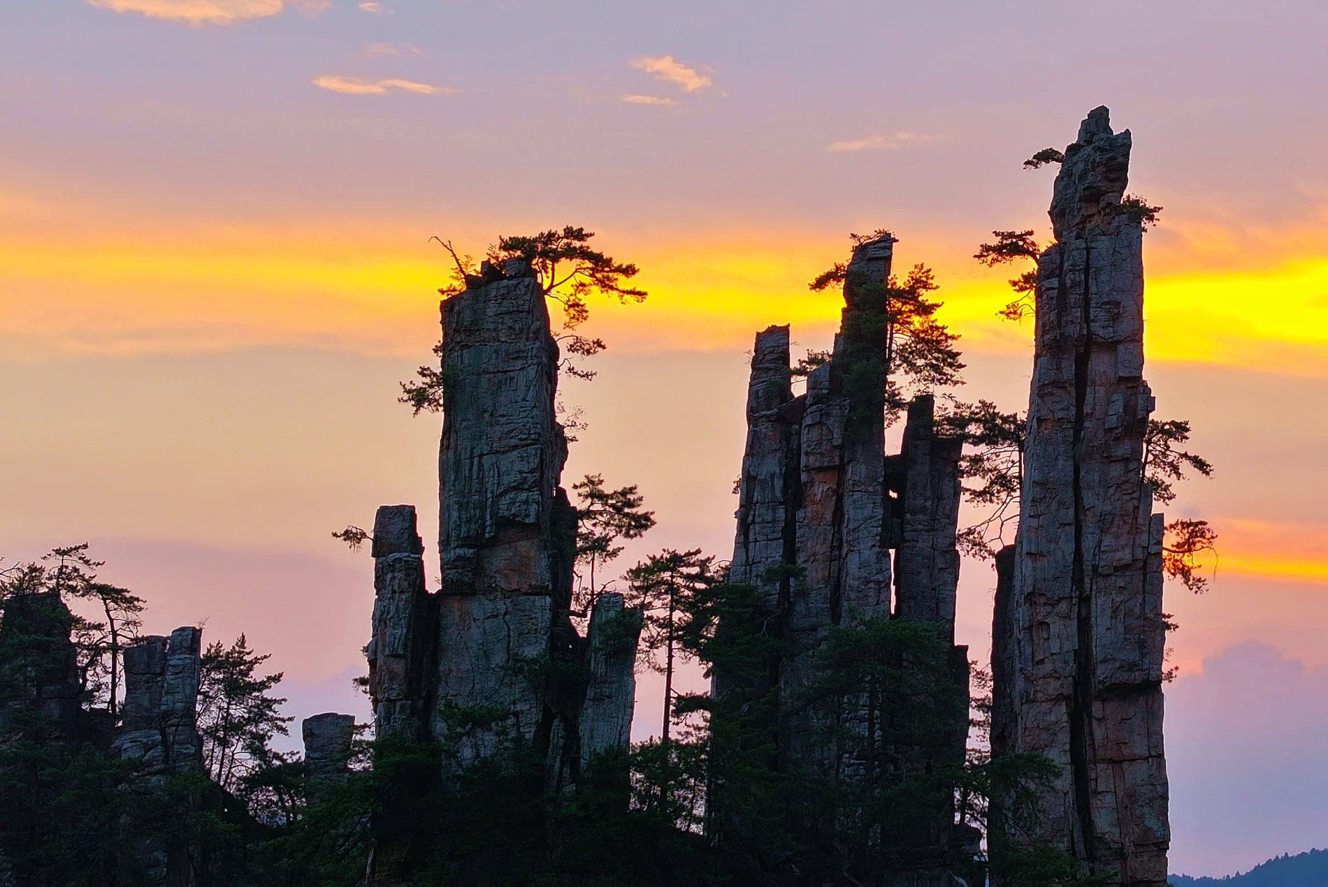 Sandstone pillars silhouetted against a warm evening sky.