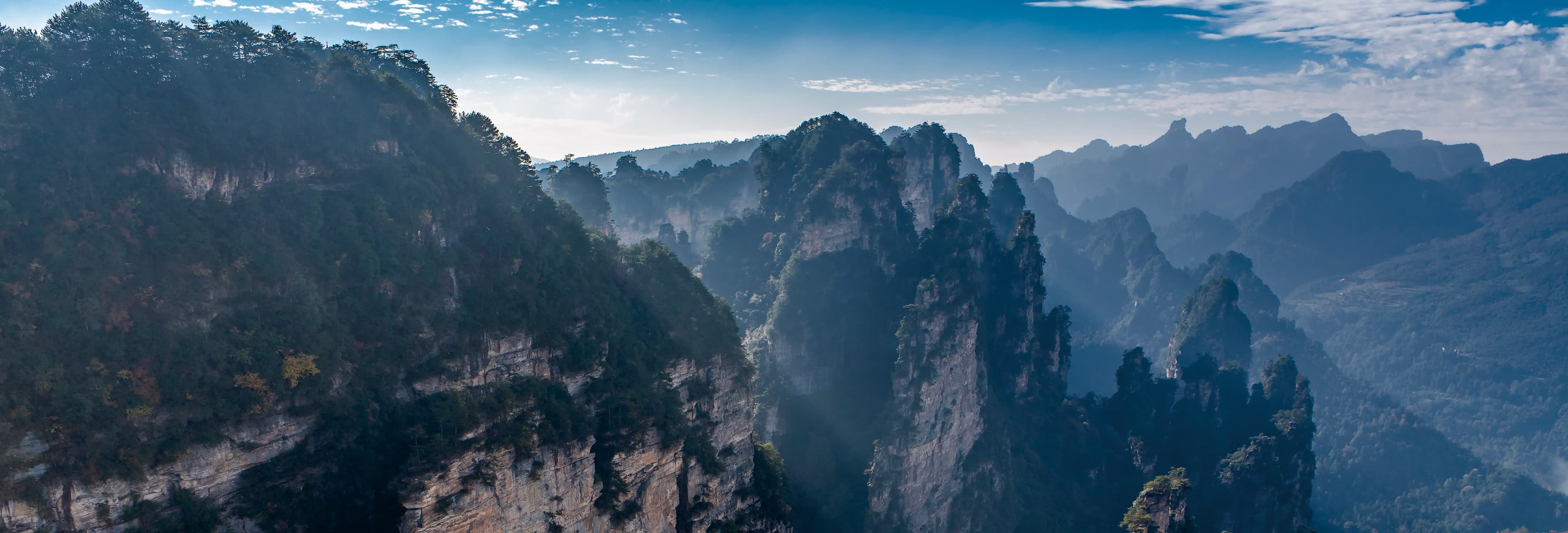 Layered Zhangjiajie peaks introducing recommended routes in the official Tour Guide Manual.